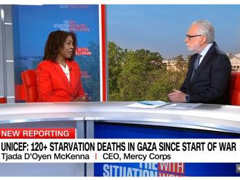 Mercy corps ceo being interviewed by cnn anchor.